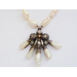 A Georgian white-metal, diamond and baroque-pearl pendant necklace, having a pansy-shaped flower-