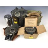 A Second World War General Service respirator, a Civilian Duty respirator, two civilian issue gas