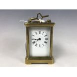 A late 19th / early 20th Century carriage clock, 11 cm excluding handle