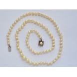 A vintage single-strand necklace of graded pearls, on a white-metal box-link clasp, stamped '