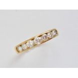 A contemporary 18ct gold and diamond half-hoop eternity ring, having an open face containing seven