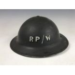 A Second World War Civil Defense helmet bearing Repair Party / Water insignia