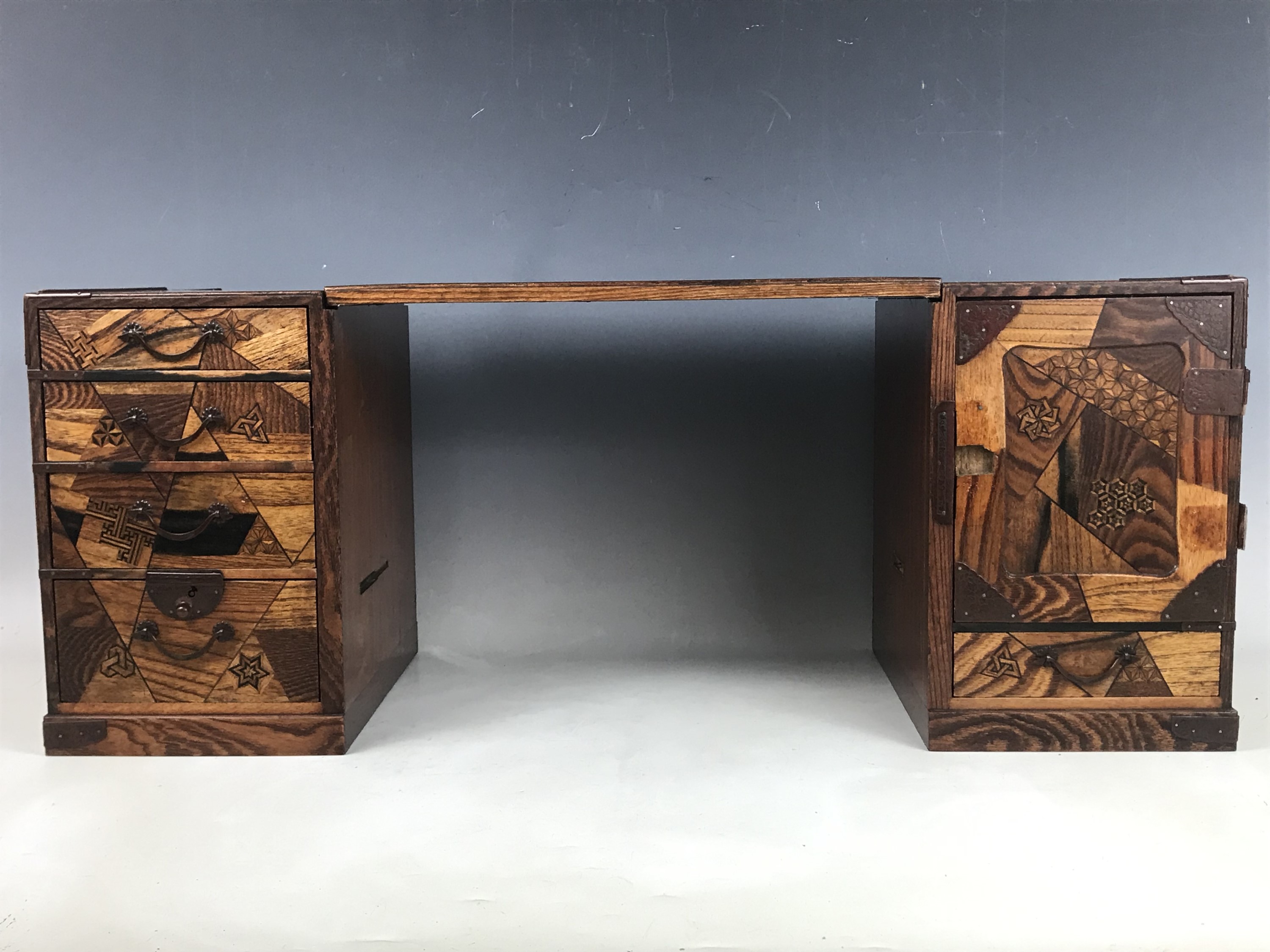 A late Meiji / Taisho Japanese kodansu cabinet / miniature kneehole desk, parquetry veneered