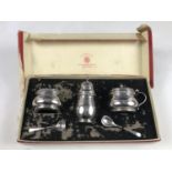 A boxed Elizabeth II silver cruet set, of baluster form, each element having a raised Celtic border,