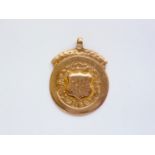 A First World War 9ct gold fob, having a shield-shaped cartouche bearing an engraved monogram,