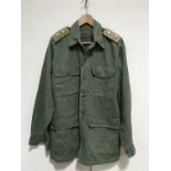 A 1945 dated jungle green tropical Aertex bush shirt, bearing slip-on rank insignia
