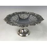 An Edwardian silver tazza, having a Chippendale style rim edged with scrolling foliage, and a finely