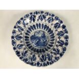 A 17th Century Delft lobed dish, having blue and white decoration, the central field incorporating