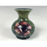 A Moorcroft Anemone pattern bud vase, of baluster form, with an everted rim and circular foot, 9 cm