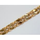 A 9ct gold bracelet, having polished and textured saltire links interspersed by lenticular