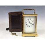 A late 19th / early 20th Century brass cased carriage clock, having a Corniche case with bevelled