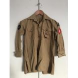 A Hitler Youth service shirt bearing Nord Nordsee district badge, Oberbann 1 and DJ-Hordenfuhrer
