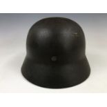 A German Model 1935 steel helmet bearing an Army decal