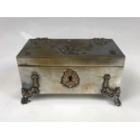 An Edwardian French electroplate bijouterie box and key, decorated with strapwork and the Coat of