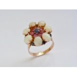 A vintage sapphire, ruby and opal flower-head cluster cocktail ring, having a central round-cut