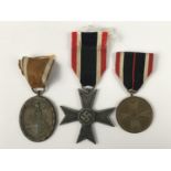 A German Third Reich West Wall Medal, a War Merit Cross and War Merit Medal