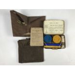 A 1942 British military anti-gas wallet, a 1940 dated gas detector brassard and a Pocket Vapour