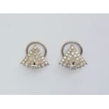A pair of Art Deco diamond ear clips, in a tiered arrangement of three brilliant-cut diamond set