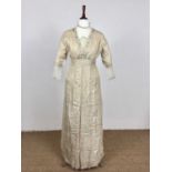 A circa 1914 champagne linen day dress, of one-piece construction, having a deep V neckline, dropped