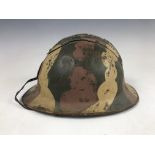 A Second World War French artillery Adrian pattern helmet bearing distinctive camouflage