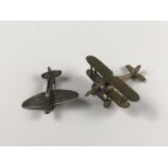 An extremely small scale brass model Sopwith Camel aircraft, together with a brooch in the form of