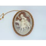 A 9ct gold and shell cameo brooch, carved in depiction of two putti clambering onto the back of a