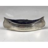 An early Edwardian silver pin cushion in the form of a boat / kayak, engraved 'A D R / Xmas 1905',