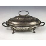 A George V silver serving dish / tureen, of oval section, having an undulating domed cover,