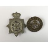 A Victorian militia badge and Oxfordshire Light Infantry helmet plate centre