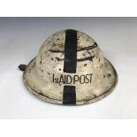 A Second World War Civil Defense First Aid Post steel helmet