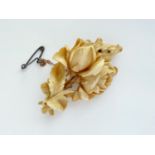 A Victorian ivory brooch carved in depiction of a cabbage rose sprig, 5.5 cm