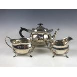 An early George V silver three-piece tea service, of Georgian influence, comprising tea pot, milk