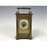 A late 19th / early 20th Century brass cased carriage clock, having a columnar case with bevelled