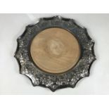 An early 20th Century electroplate bread / cheese board by Walker and Hall, having a cusped and