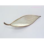 A Willy Winnaess for David Andersen Norwegian silver leaf brooch, basse-taille enamelled in white,