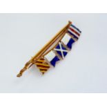 A vintage enamelled 9ct gold nautical brooch, modelled in the form of a flag pole flying five