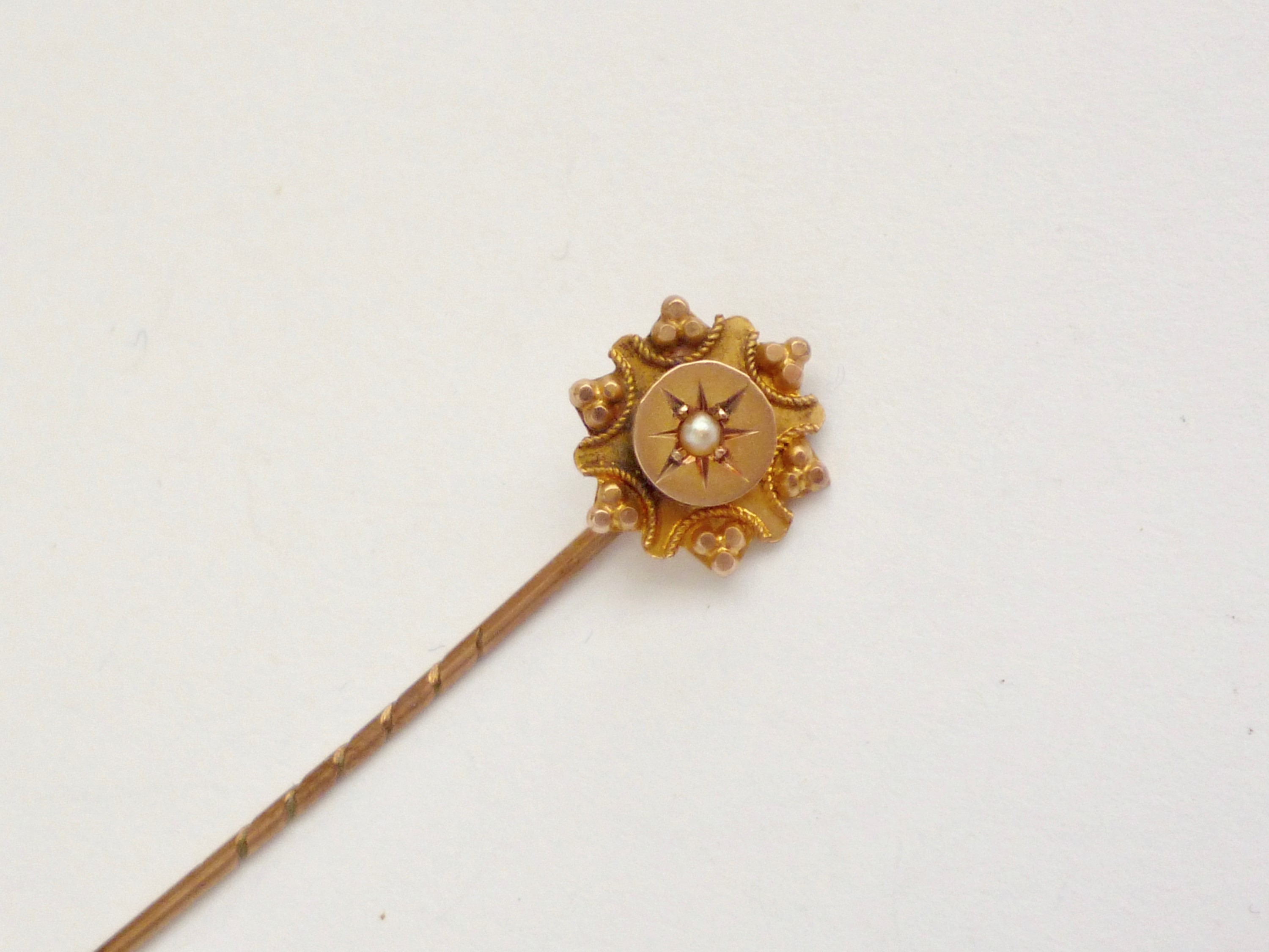 A late Victorian 9ct gold and split seed pearl stick pin, gypsy set within a pelleted and cannetille - Image 2 of 3