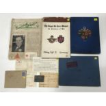 A collection of Second World War Prisoner of War items including an identity disc and related period