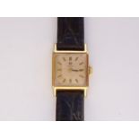 A lady's vintage gold-plated Omega wrist watch, having a square silvered face and baton markers,
