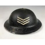 A Second World War Civil Defense Warden's helmet bearing rank stripes