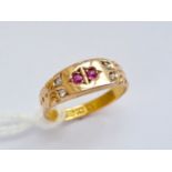 A late Victorian 15ct gold, ruby and diamond ring, the face being sunken set with a pair of round-