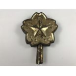 An Imperial Japanese tinplate banner staff finial