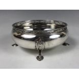 A George V silver bowl, of oblate form, having a reticulated cylindrical collar and four bell-flower