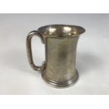 An Edwardian silver tankard, of everted cylindrical form, engraved with a monogram, Colen Hewer,