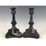 A pair of 19th Century purple malachite candlesticks attributed to Sowerby, having inverted bell