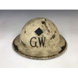 A Second World War Civil Defense steel helmet bearing rank and GW insignia