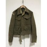 A Second World War Serge Battledress blouse bearing Home Guard shoulder titles, (lacking label)
