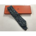 A gentleman's boxed Hermes silk tie / cravat, pattern No 7537 1A, incorporating green foliage and