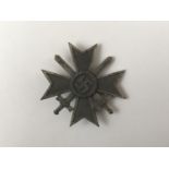 A German Third Reich War Merit Cross with swords, first class, pin marked 4