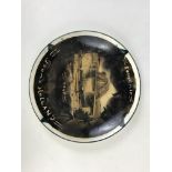 A decorated plate bearing message Souvenir from Holland, 1945 and an applied photograph of